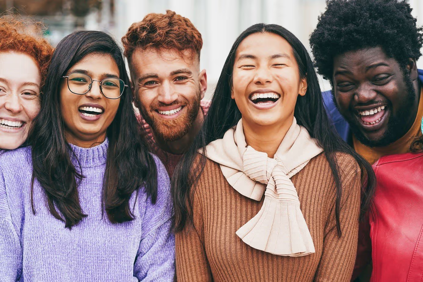 Smiling young adults of different backgrounds, the communities Ruhwell Med serves across Texas